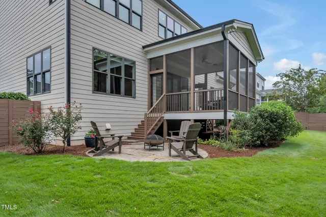 a dining room with furniture a chandelier and wooden floor