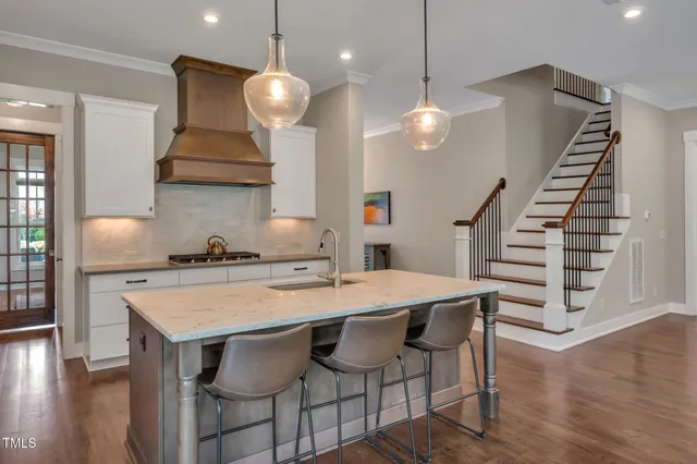 a bedroom with a large bed and a potted plant