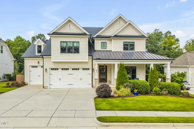 an aerial view of a house with a swimming pool patio and lake view