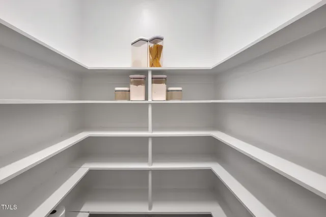 a spacious bathroom with a double vanity sink a large mirror and a bathtub