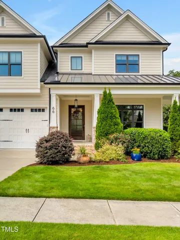 a view of a couches in the patio with potted plants