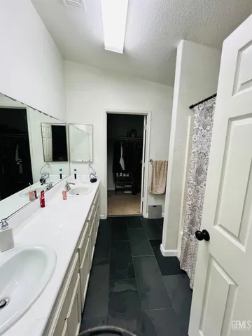 a en suite bathroom with a sink and mirror