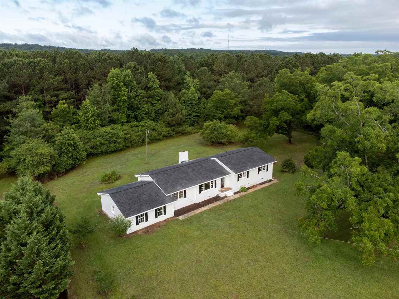 an aerial view of a house with a garden