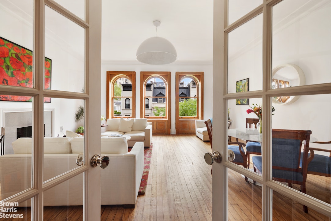 a living room with furniture and large windows