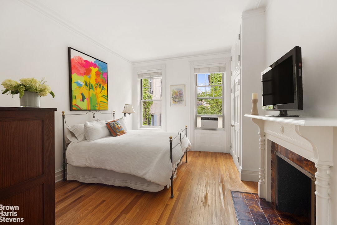 14 East 92nd Street, Unit 4 Manhattan, NY 10128 - Photo 5 of 8 a bedroom with a bed and a flat screen tv