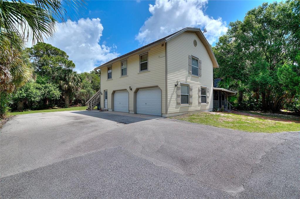 3641 Turtle Mound Road Melbourne, FL 32934 - Photo 52 of 77 a front view of a house with a yard and garage