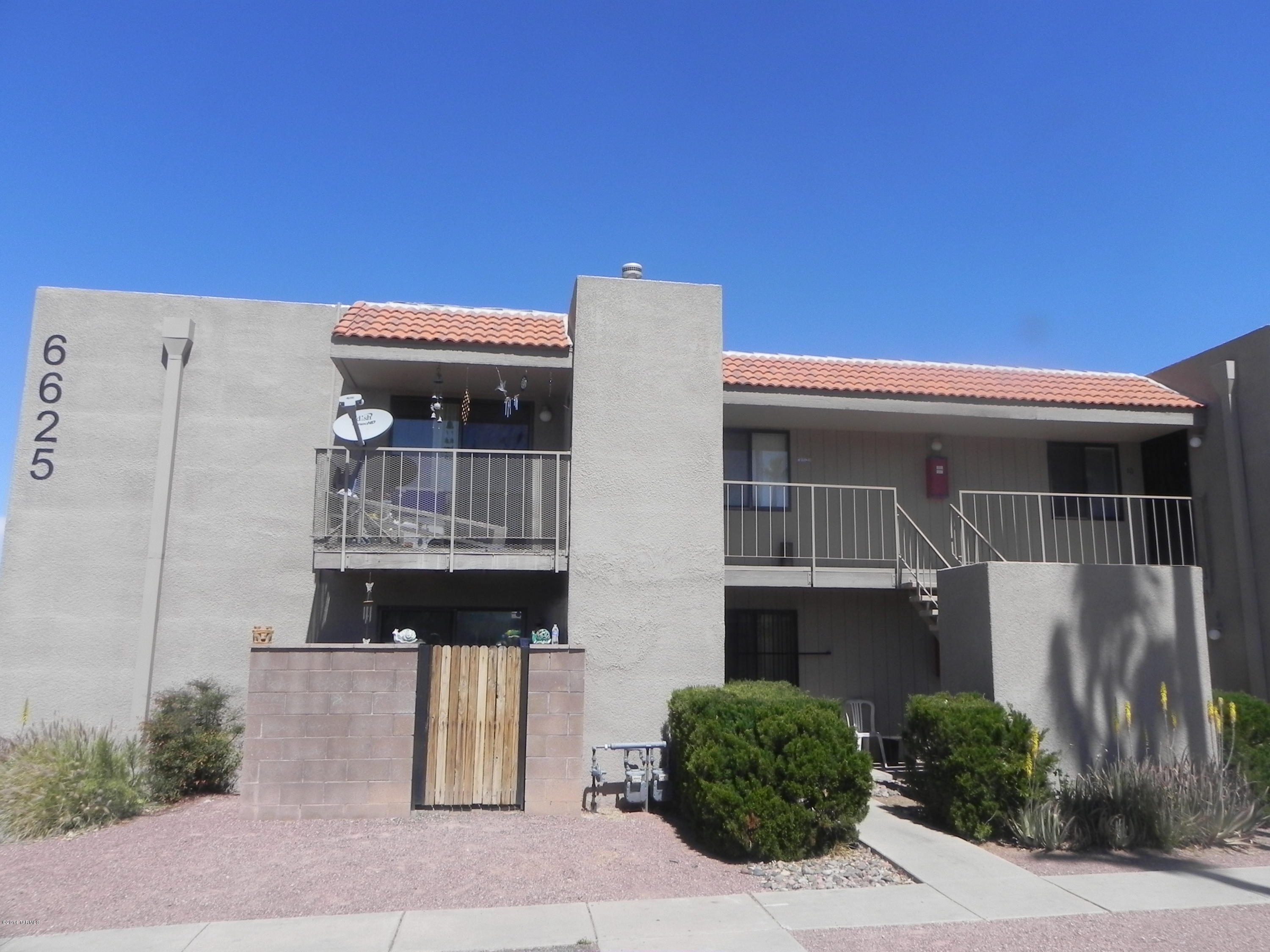 6625 East Golf Links Road, Unit 2 Tucson, AZ 85730 - Photo 1 of 14 a front view of a house with a yard