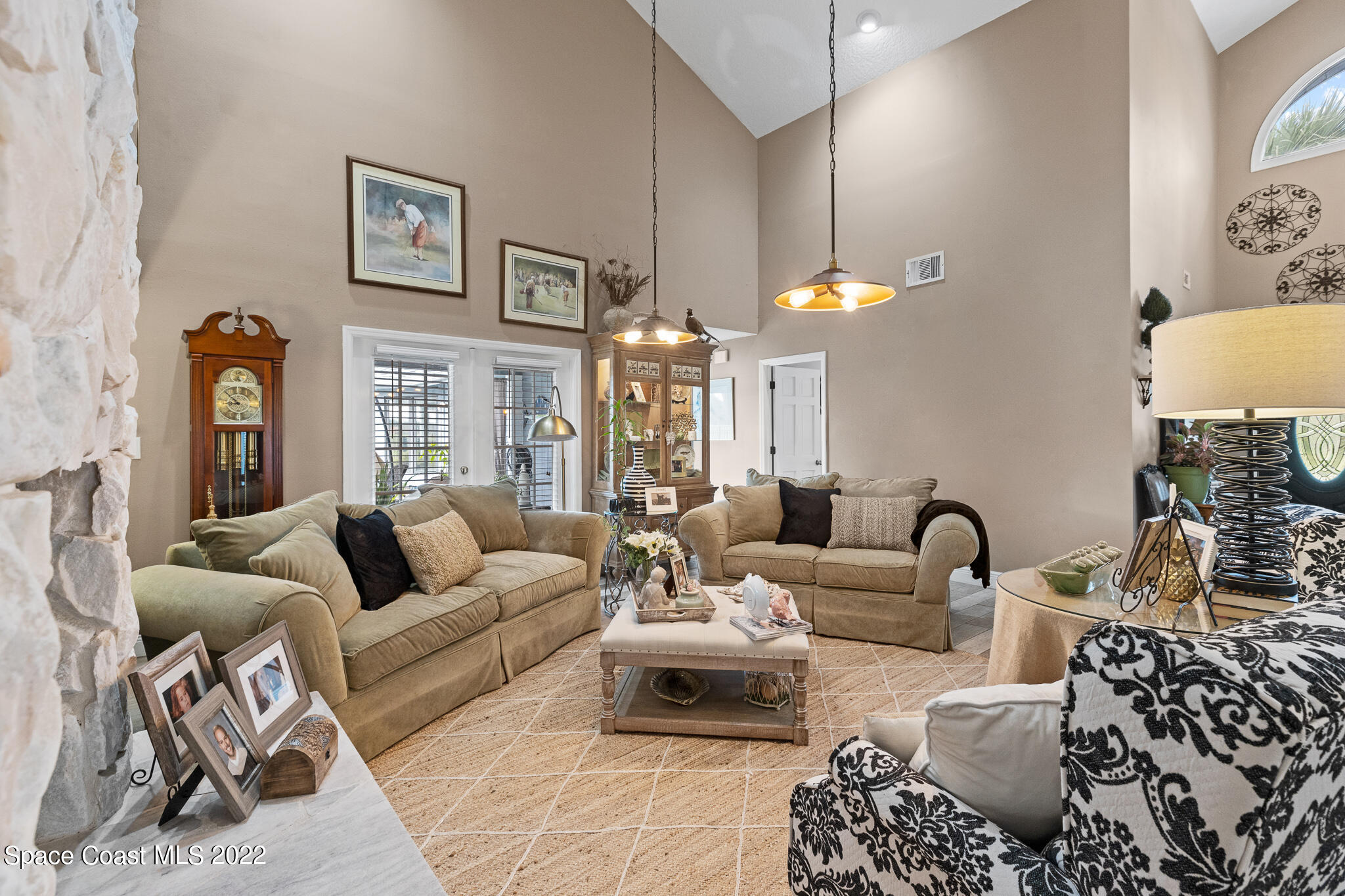 810 Kerry Downs Circle Melbourne, FL 32940 - Photo 13 of 59 a living room with furniture and a chandelier