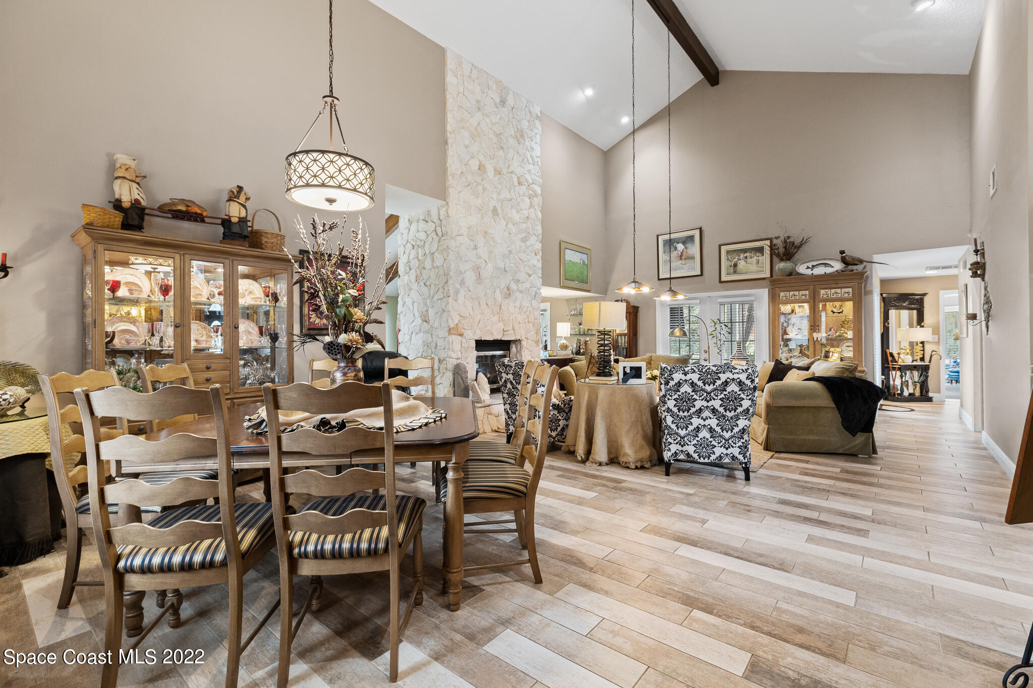 810 Kerry Downs Circle Melbourne, FL 32940 - Photo 15 of 59 a view of a dining room and livingroom with furniture wooden floor a chandelier
