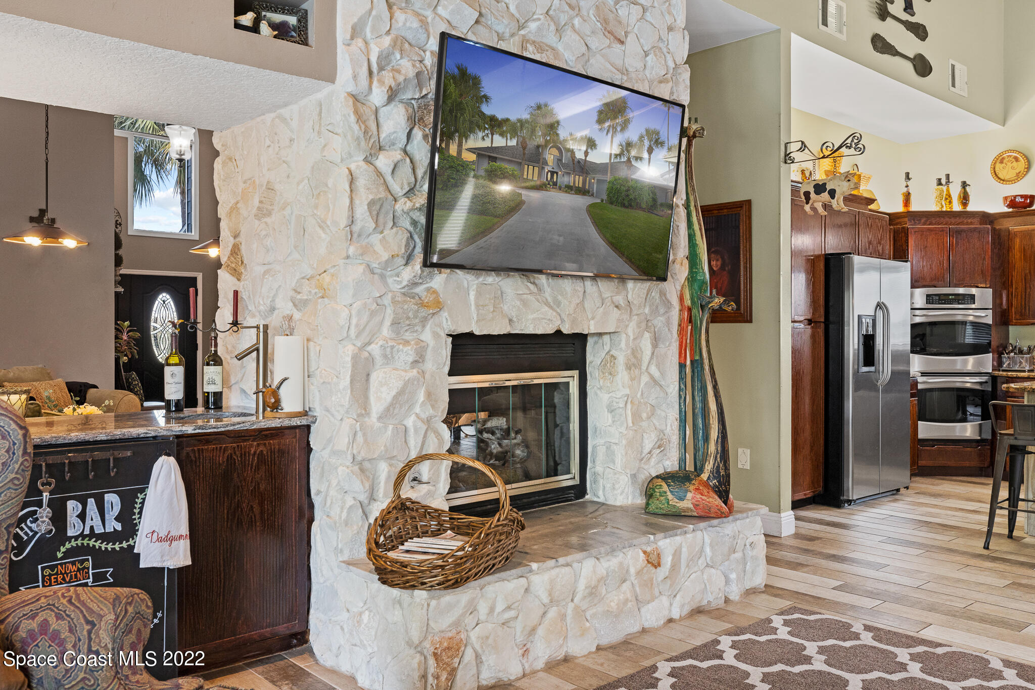 810 Kerry Downs Circle Melbourne, FL 32940 - Photo 17 of 59 a living room with furniture a flat screen tv and a fireplace