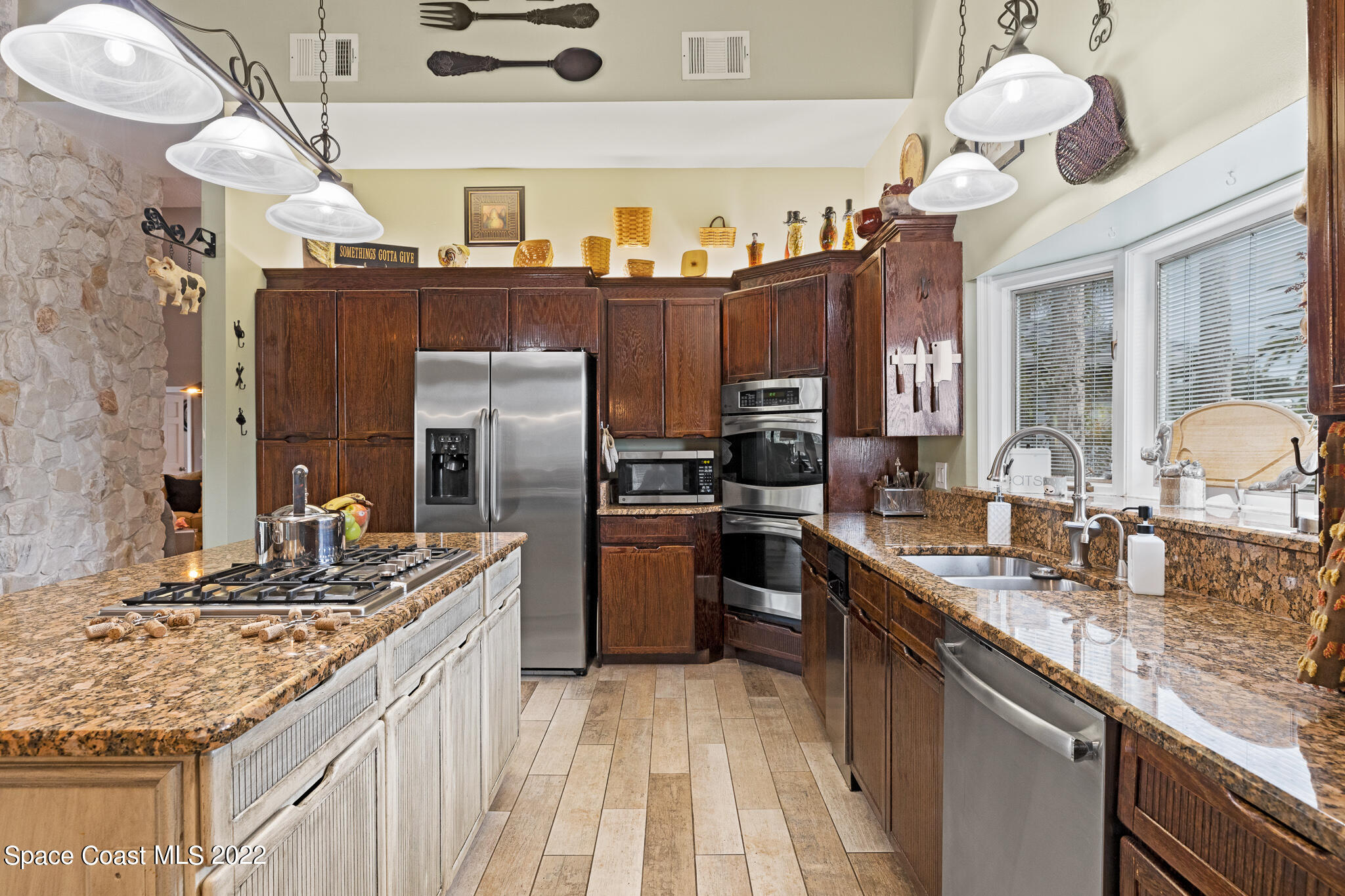 810 Kerry Downs Circle Melbourne, FL 32940 - Photo 22 of 59 a kitchen with stainless steel appliances granite countertop a sink and cabinets