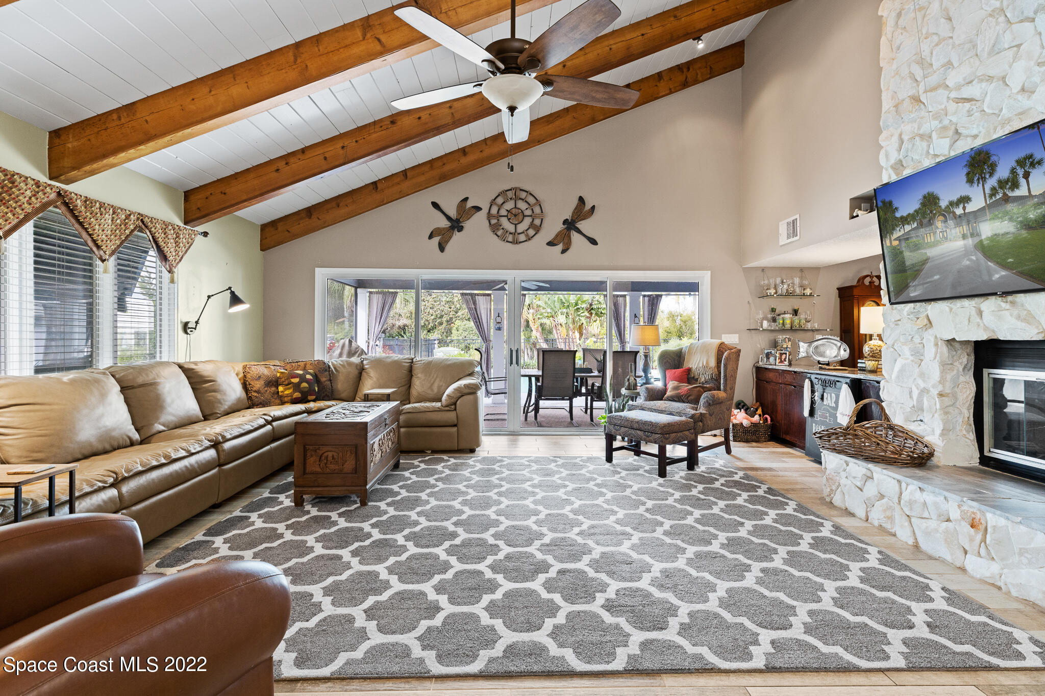 810 Kerry Downs Circle Melbourne, FL 32940 - Photo 25 of 59 a living room with furniture a fireplace and a flat screen tv
