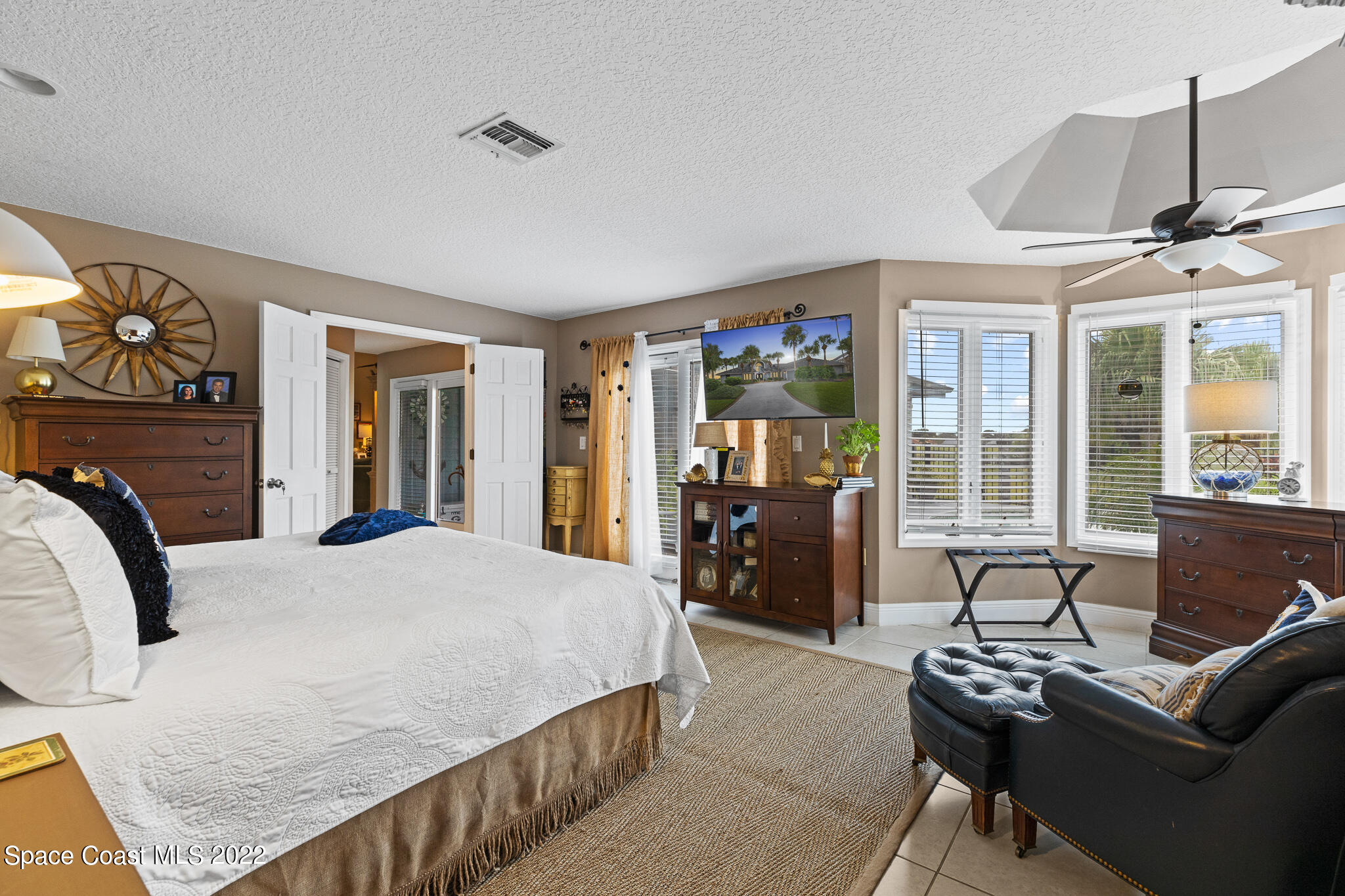 810 Kerry Downs Circle Melbourne, FL 32940 - Photo 29 of 59 a bedroom with furniture and a large window