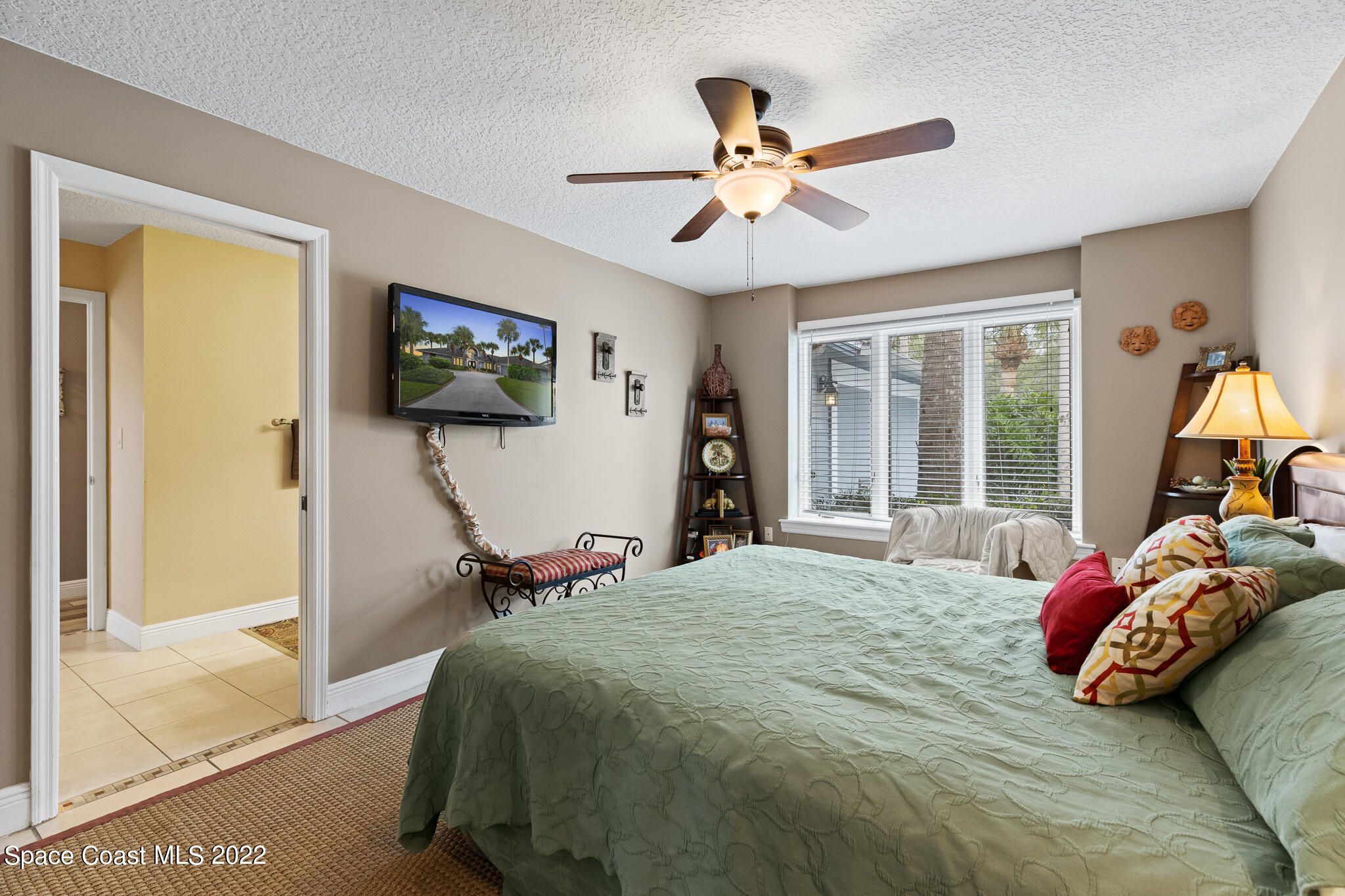 810 Kerry Downs Circle Melbourne, FL 32940 - Photo 36 of 59 a bedroom with a bed and a flat screen tv