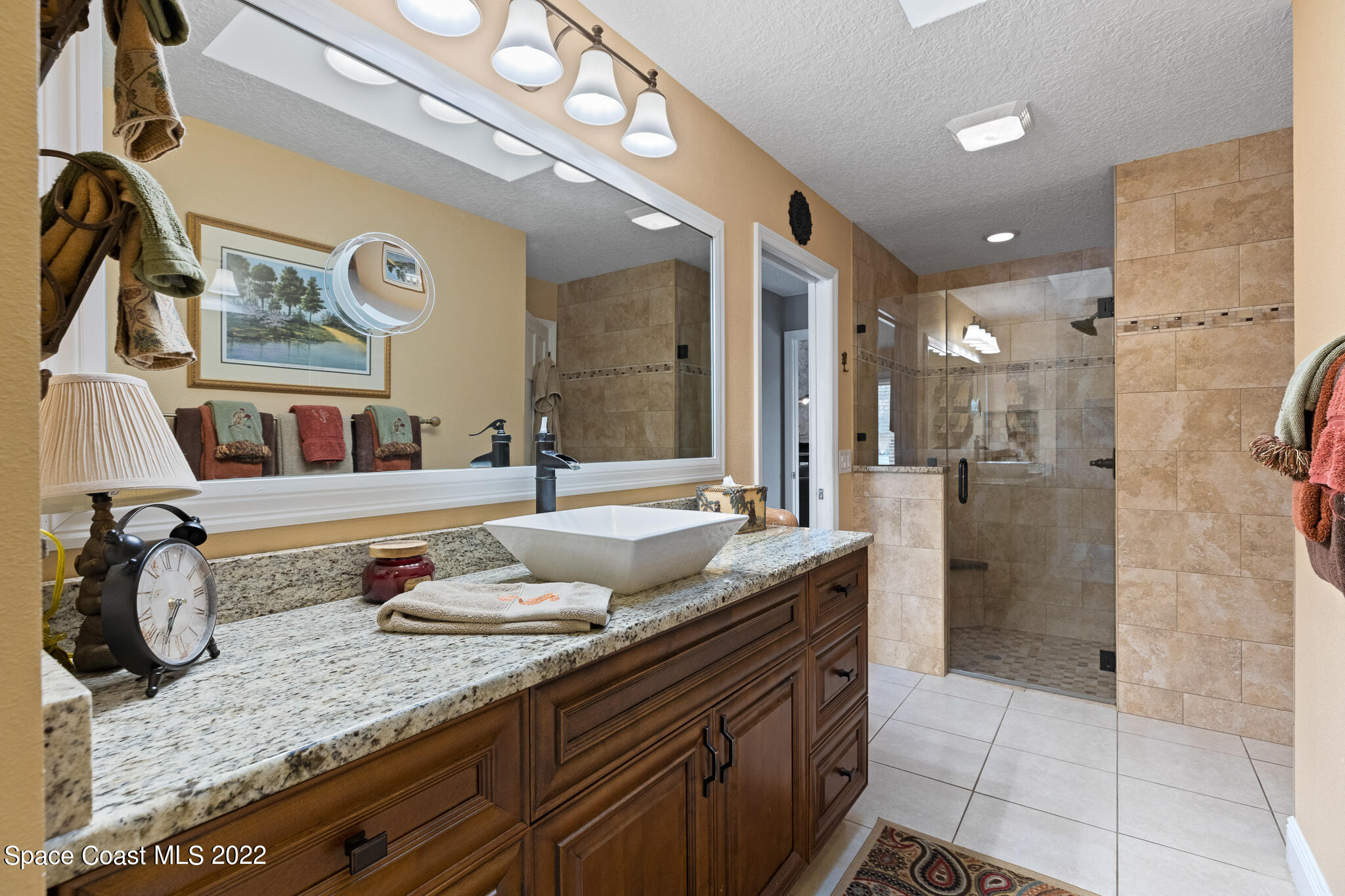 810 Kerry Downs Circle Melbourne, FL 32940 - Photo 37 of 59 a bathroom with a granite countertop sink mirror and shower