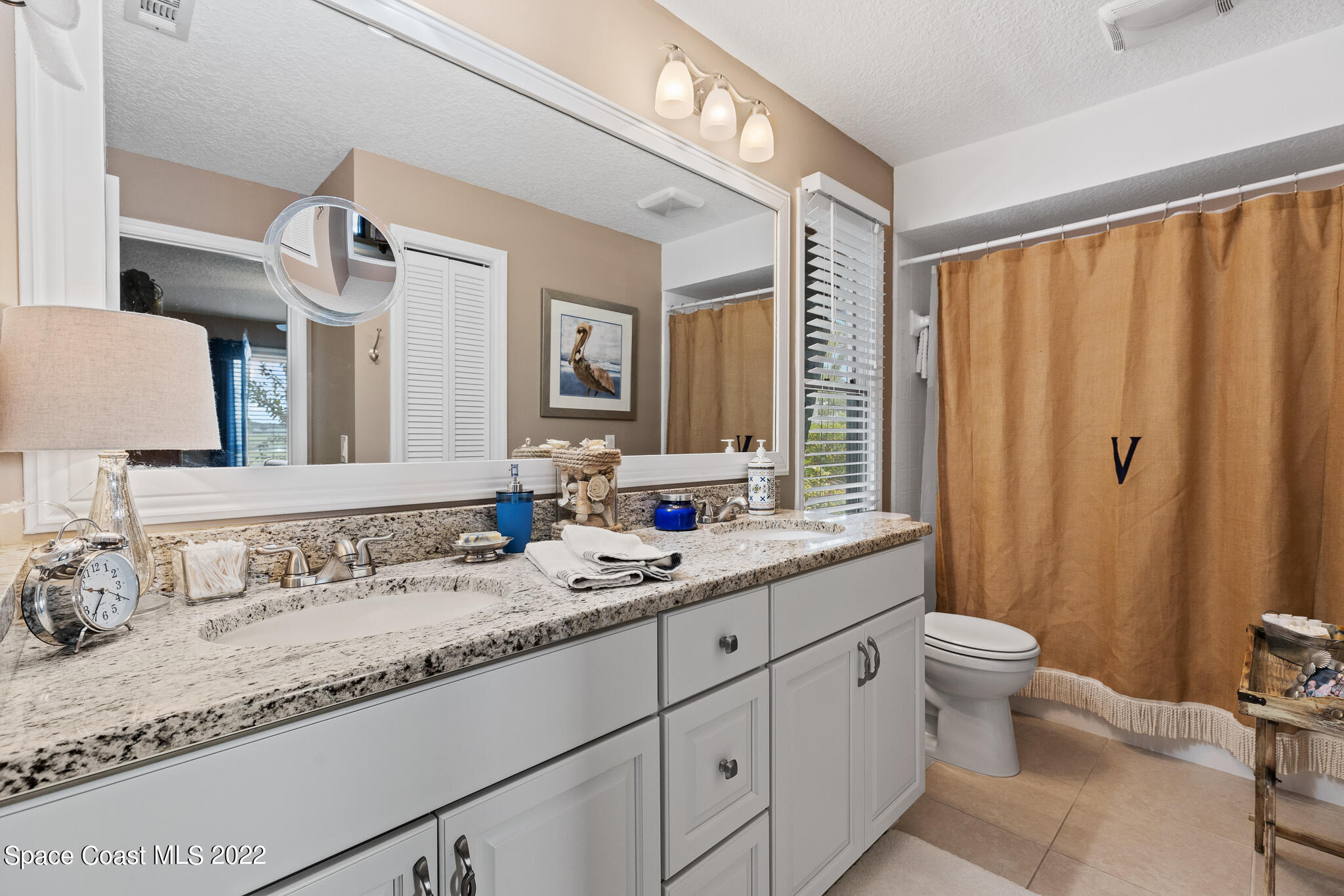 810 Kerry Downs Circle Melbourne, FL 32940 - Photo 40 of 59 a bathroom with double sink and a mirror
