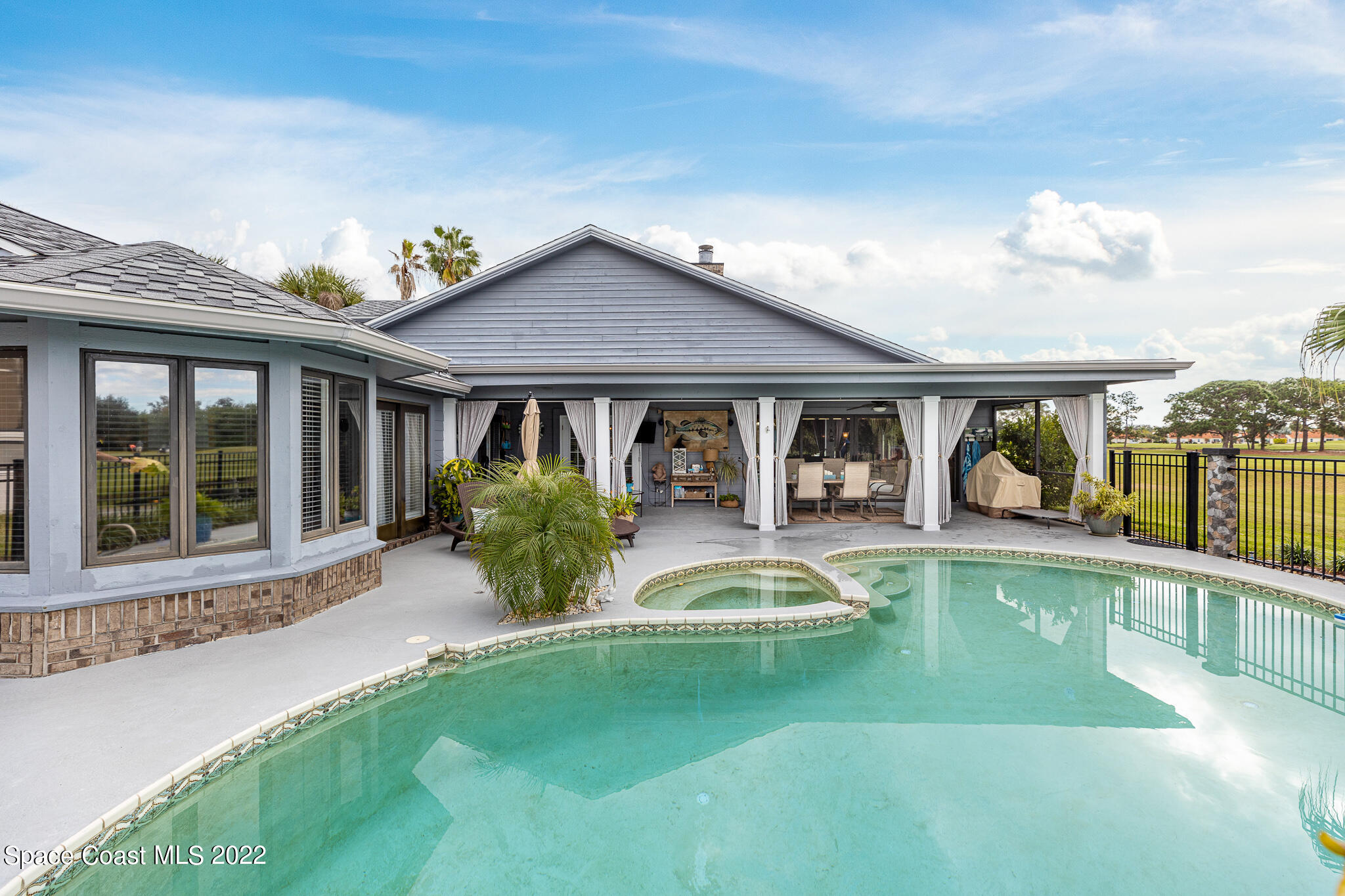 810 Kerry Downs Circle Melbourne, FL 32940 - Photo 45 of 59 a front view of a house with swimming pool having outdoor seating