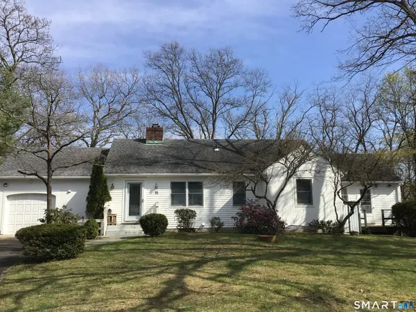 a view of a house with a large tree and a big yard