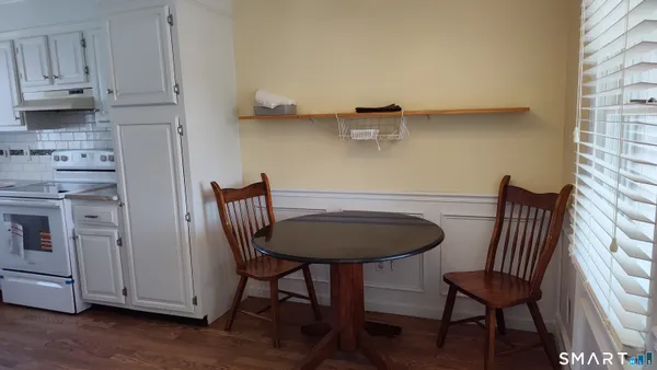 a view of a dining room with furniture and wooden floor
