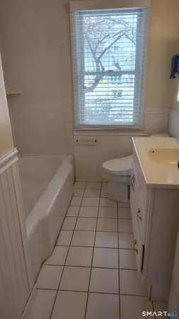 a bathroom with a sink a toilet and bathtub