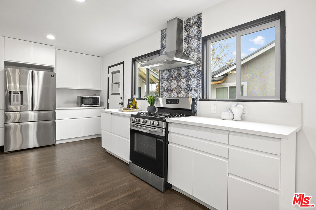 4161 Deborah Street Simi Valley, CA 93063 - Photo 7 of 14 a kitchen with granite countertop a sink stainless steel appliances and cabinets