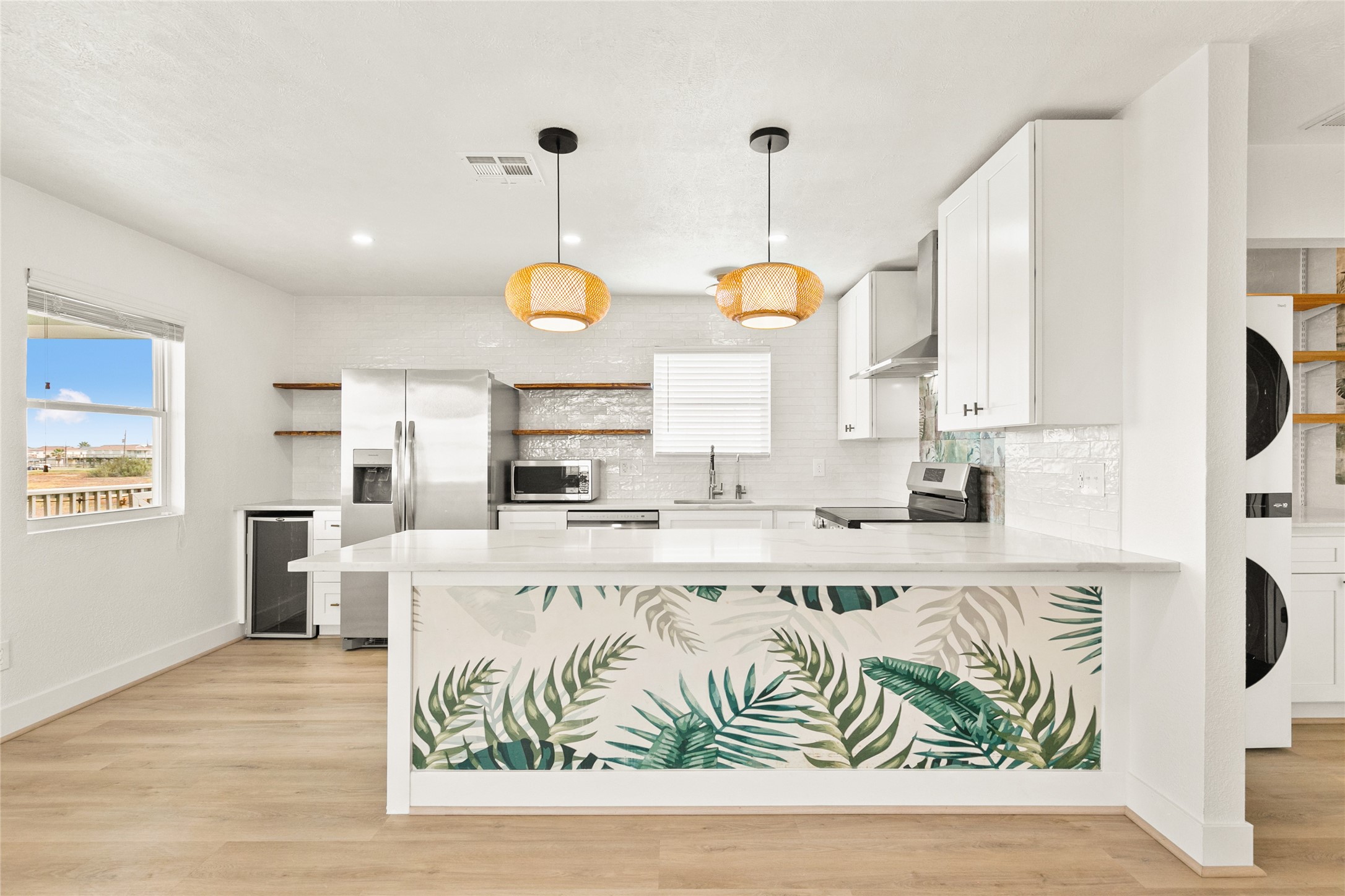 715 Caisson Street Surfside Beach, TX 77541 - Photo 12 of 35 a kitchen with stainless steel appliances granite countertop a sink a stove and a wooden floors