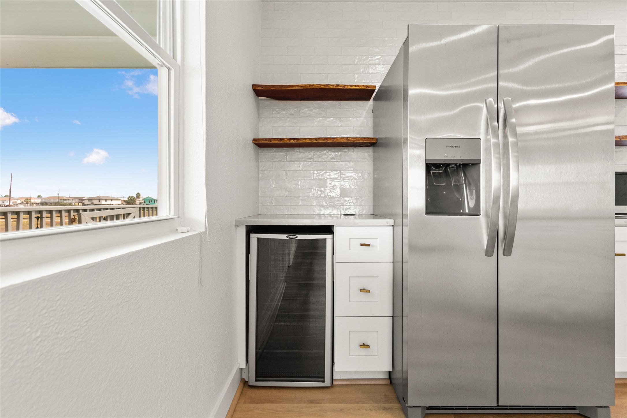 715 Caisson Street Surfside Beach, TX 77541 - Photo 14 of 35 a kitchen with a refrigerator and cabinets