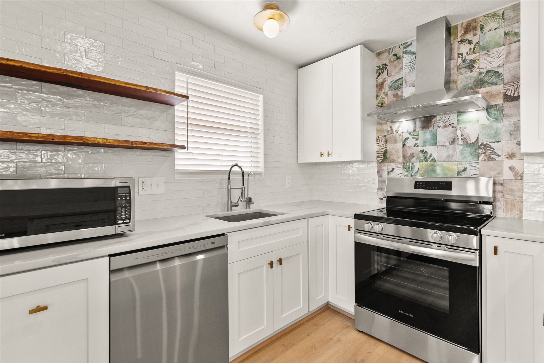 715 Caisson Street Surfside Beach, TX 77541 - Photo 15 of 35 a kitchen with granite countertop a stove oven and sink