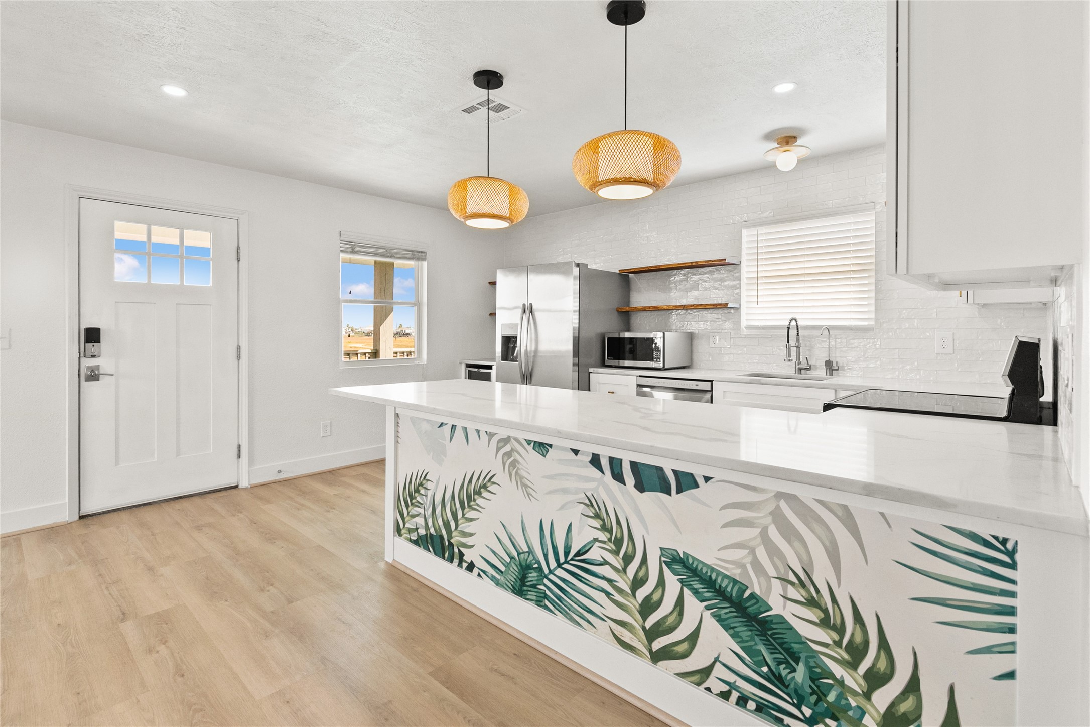 715 Caisson Street Surfside Beach, TX 77541 - Photo 16 of 35 a large kitchen with stainless steel appliances granite countertop a sink a stove and a large window
