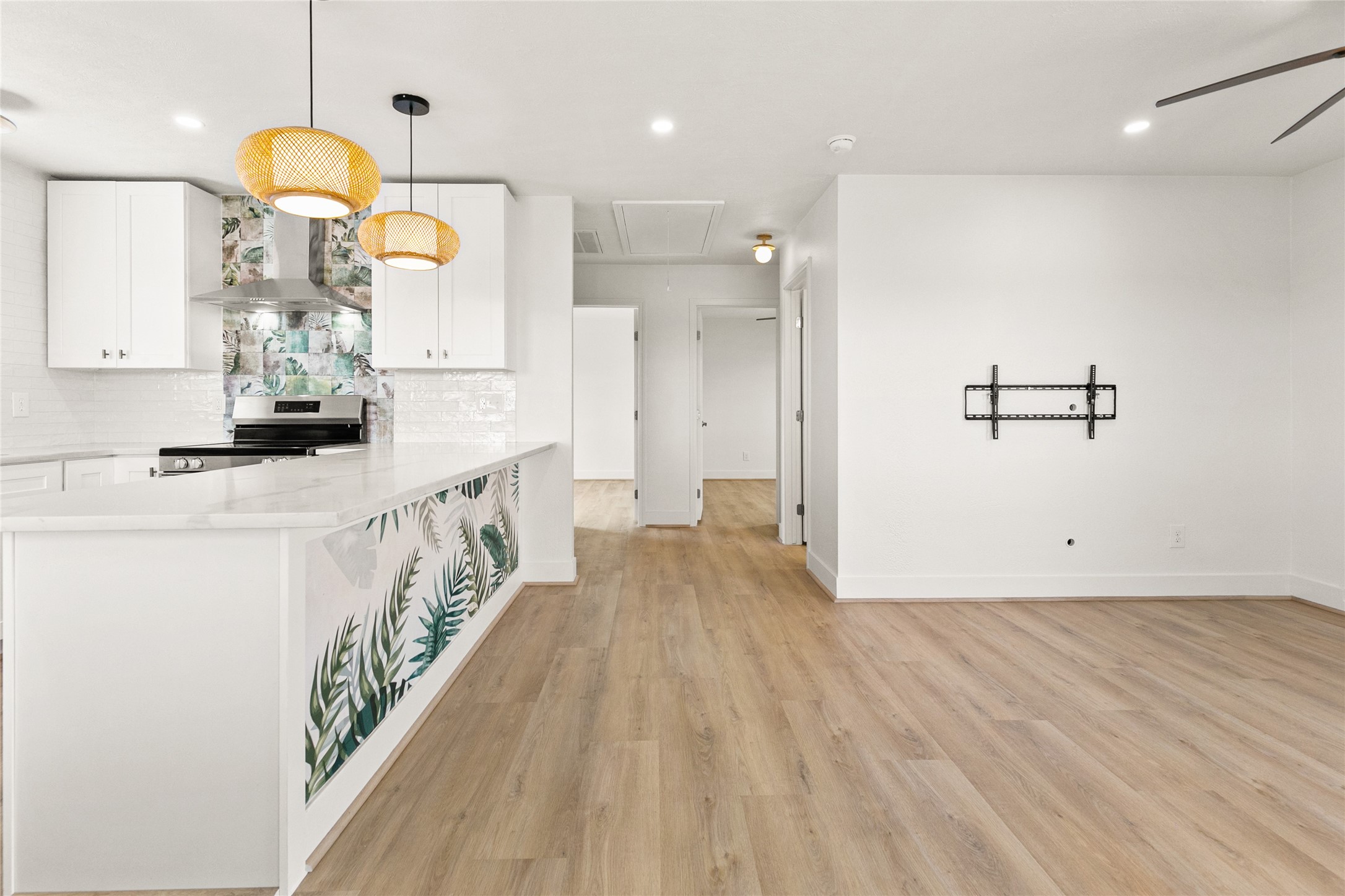715 Caisson Street Surfside Beach, TX 77541 - Photo 19 of 35 a view of a kitchen interior and hall with wooden floor