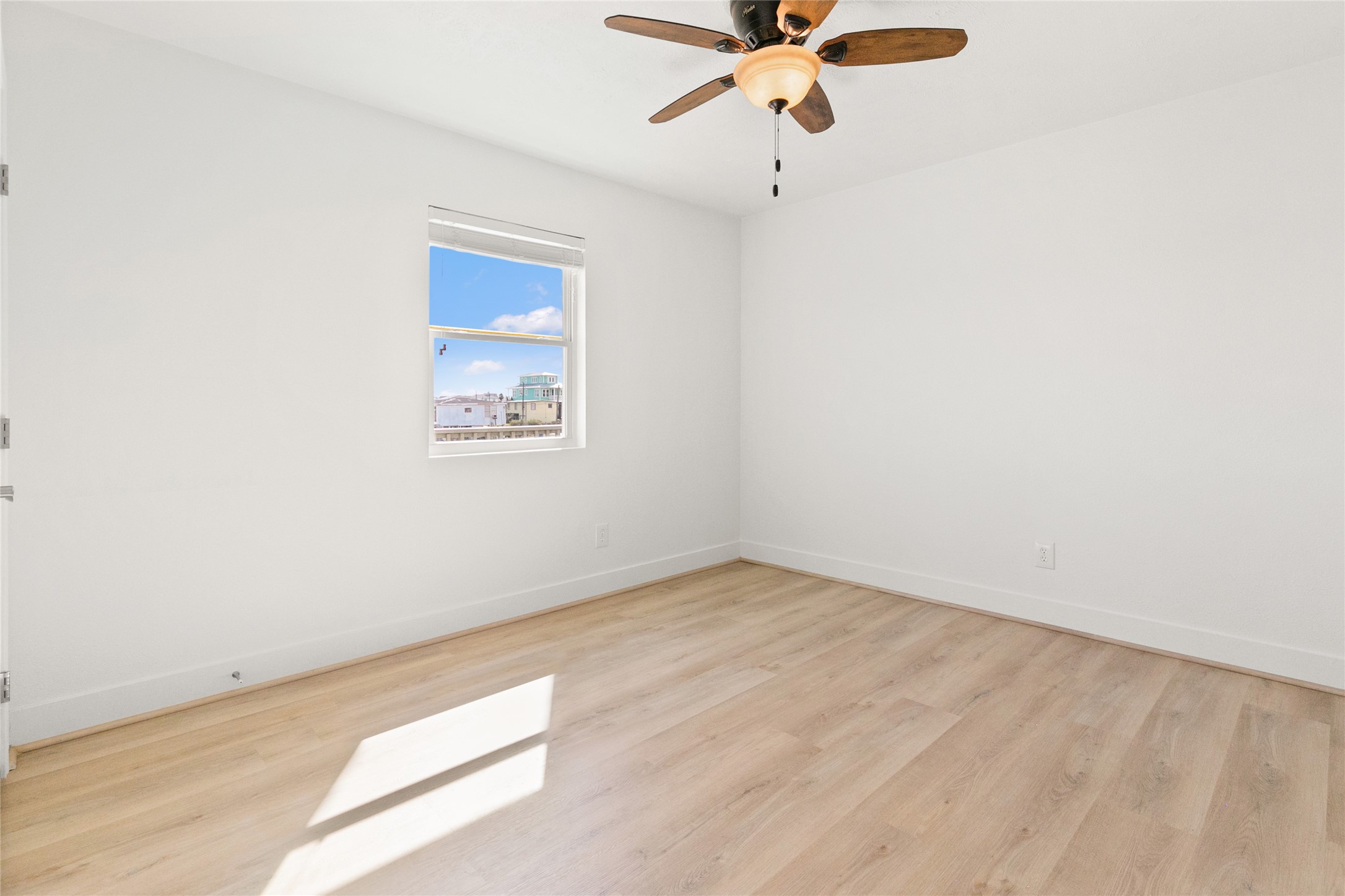 715 Caisson Street Surfside Beach, TX 77541 - Photo 20 of 35 an empty room with a window and a fan