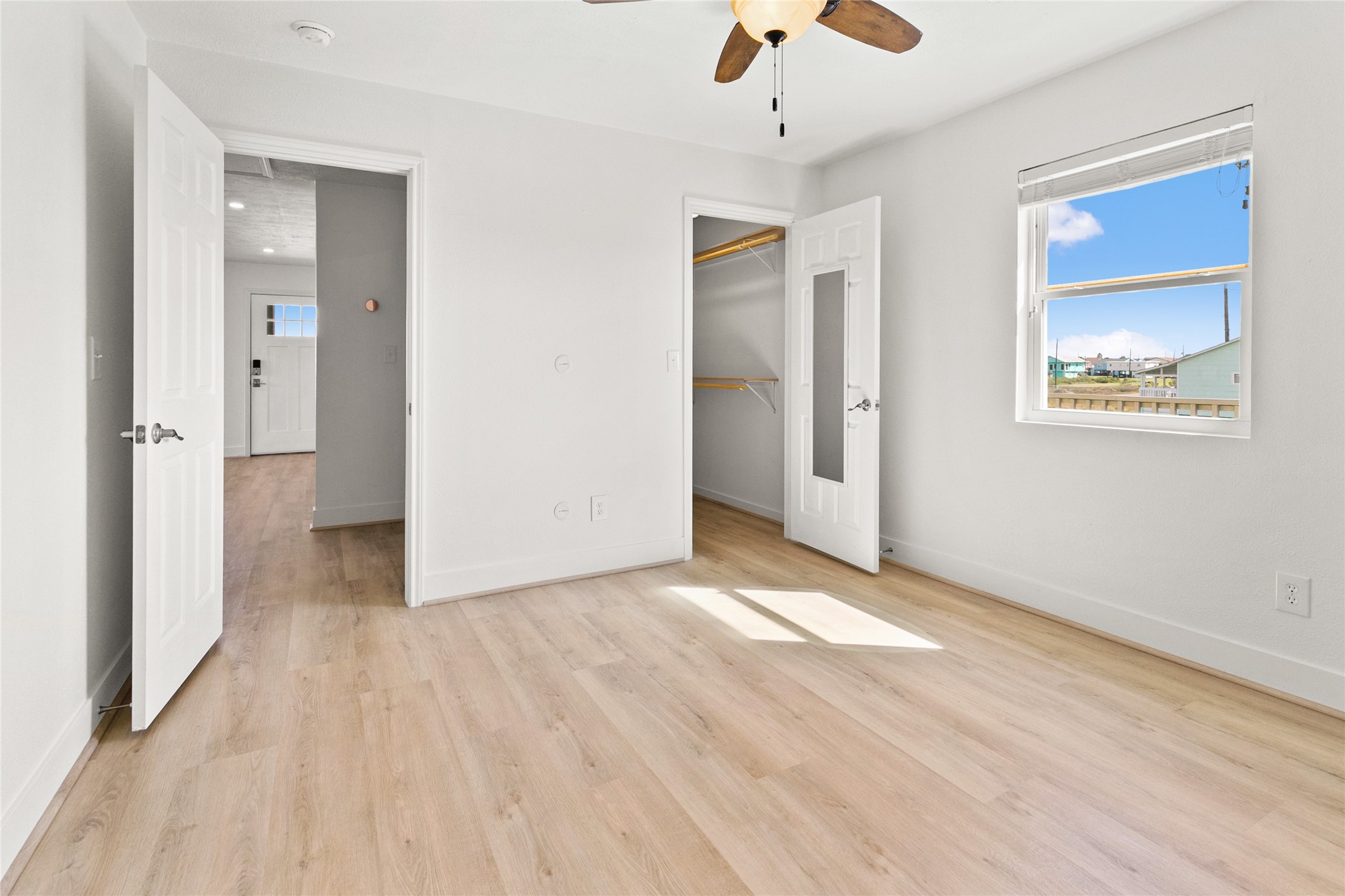 715 Caisson Street Surfside Beach, TX 77541 - Photo 21 of 35 a view of an empty room with window and wooden floor