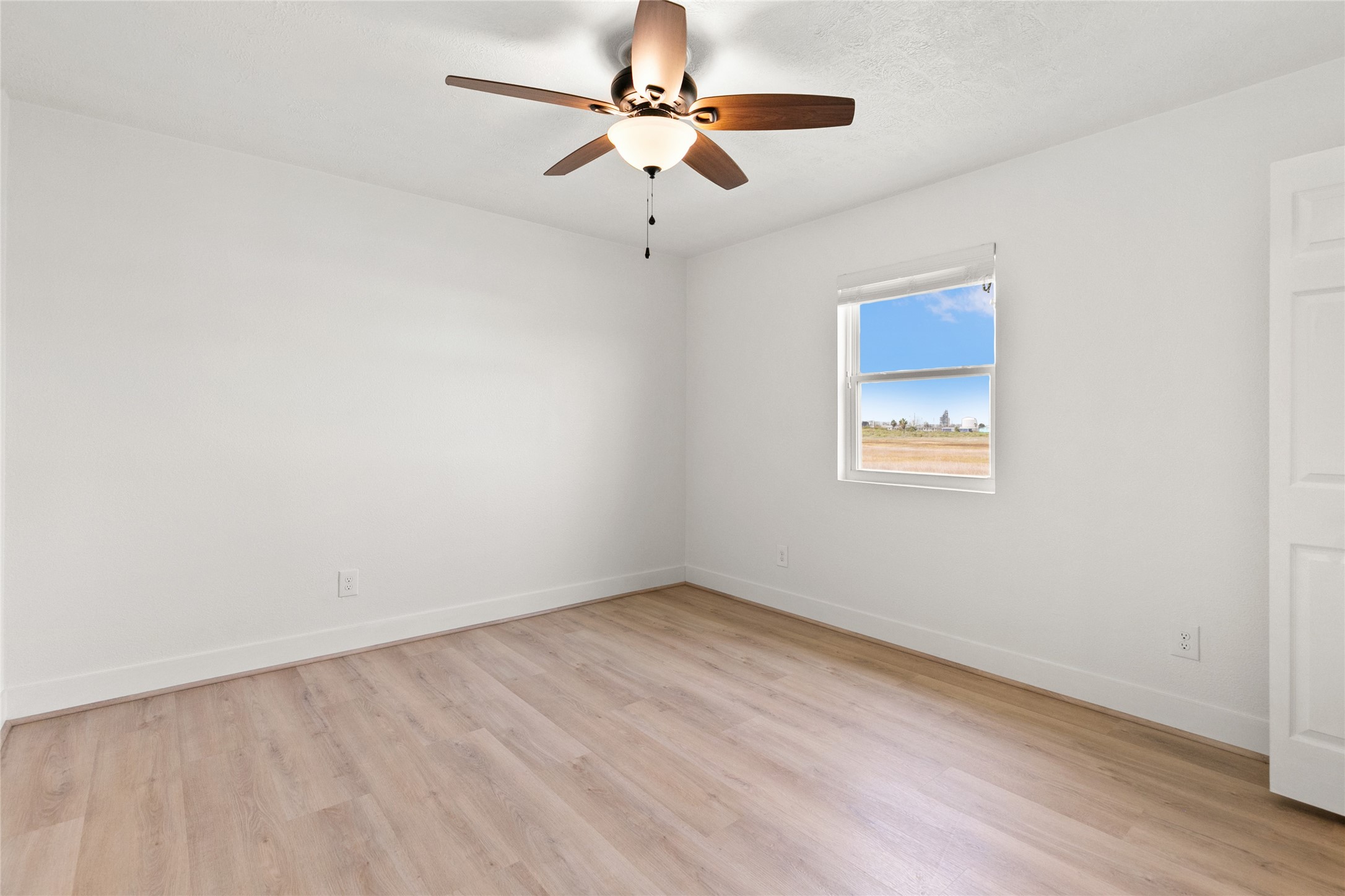 715 Caisson Street Surfside Beach, TX 77541 - Photo 24 of 35 an empty room with a fan & a ceiling fan