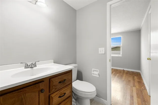 a bathroom with a sink toilet and vanity