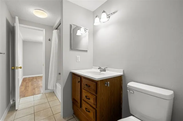 a bathroom with a sink a toilet and mirror