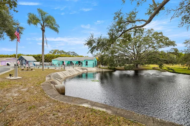 a view of a house with swimming pool and sitting area