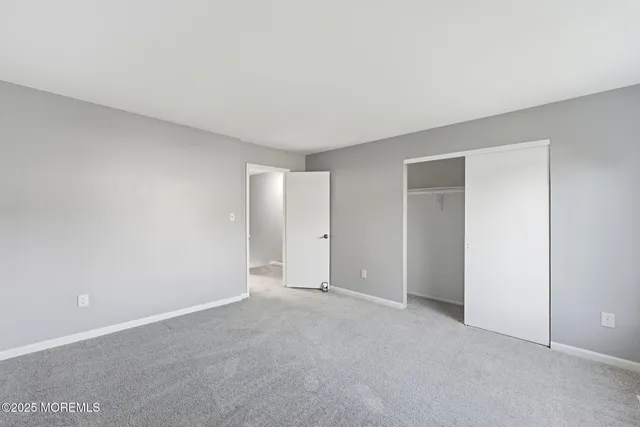 a view of an empty room and closet area