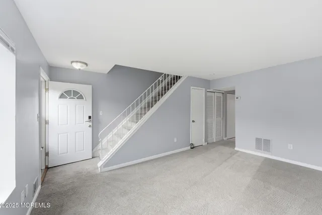 a view of an empty room with stairs