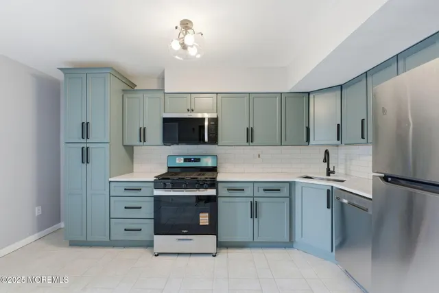 a kitchen with a sink stainless steel appliances and cabinets