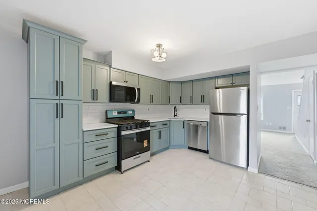 a kitchen with a refrigerator stove and sink