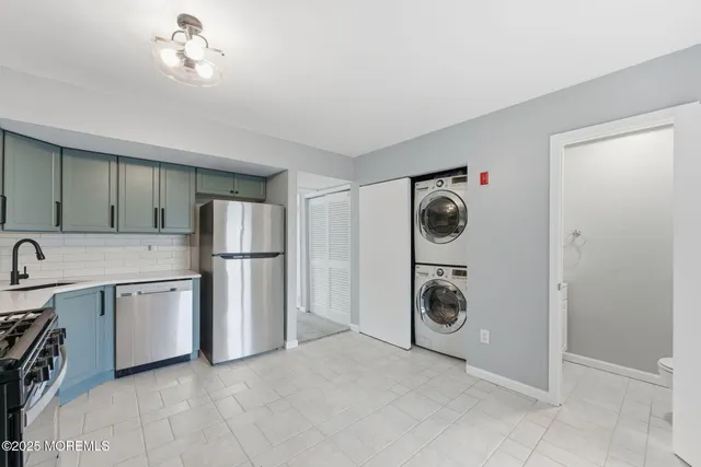 a utility room with cabinets washer and dryer