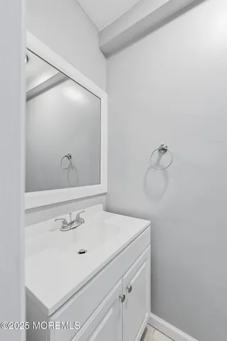a bathroom with a sink and mirror