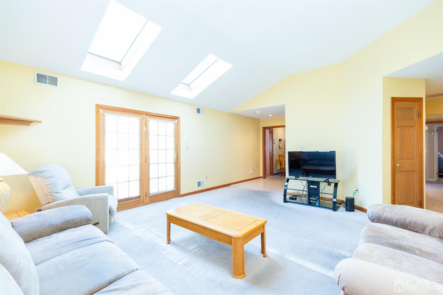 1 Crescent Road Edison, NJ 08817 - Photo 17 of 36 a living room with furniture a flat screen tv and a window