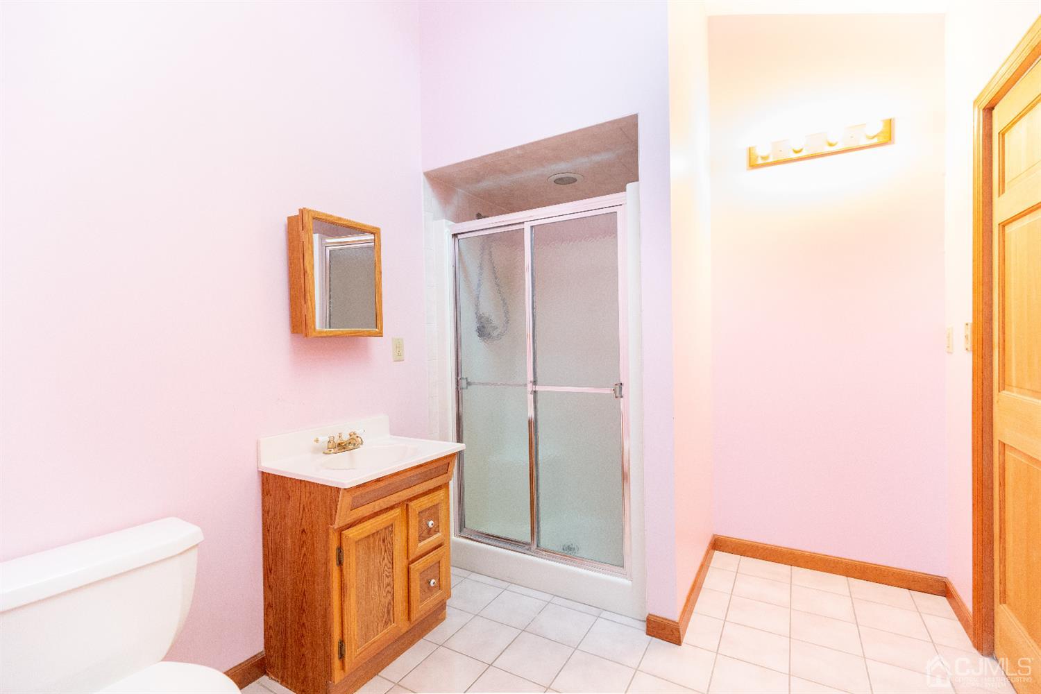 1 Crescent Road Edison, NJ 08817 - Photo 21 of 36 a bathroom with a sink a toilet and a mirror