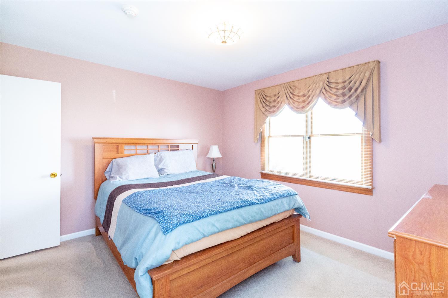 1 Crescent Road Edison, NJ 08817 - Photo 23 of 36 a bedroom with a bed and window