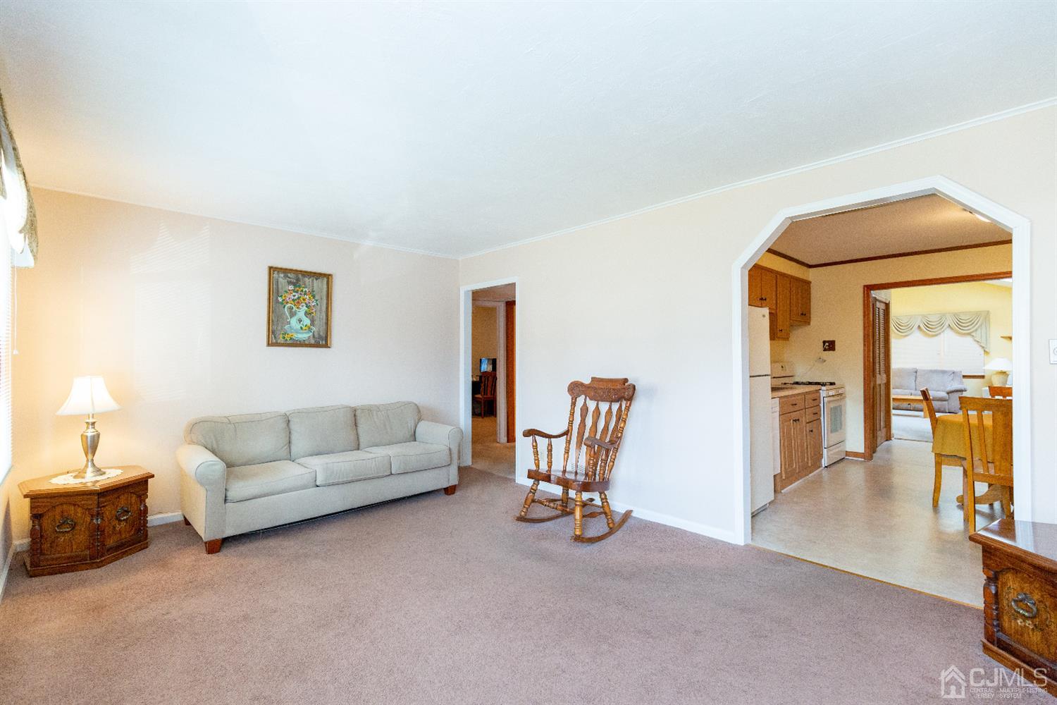 1 Crescent Road Edison, NJ 08817 - Photo 6 of 36 a living room with furniture a dining table with wooden floor and a large window