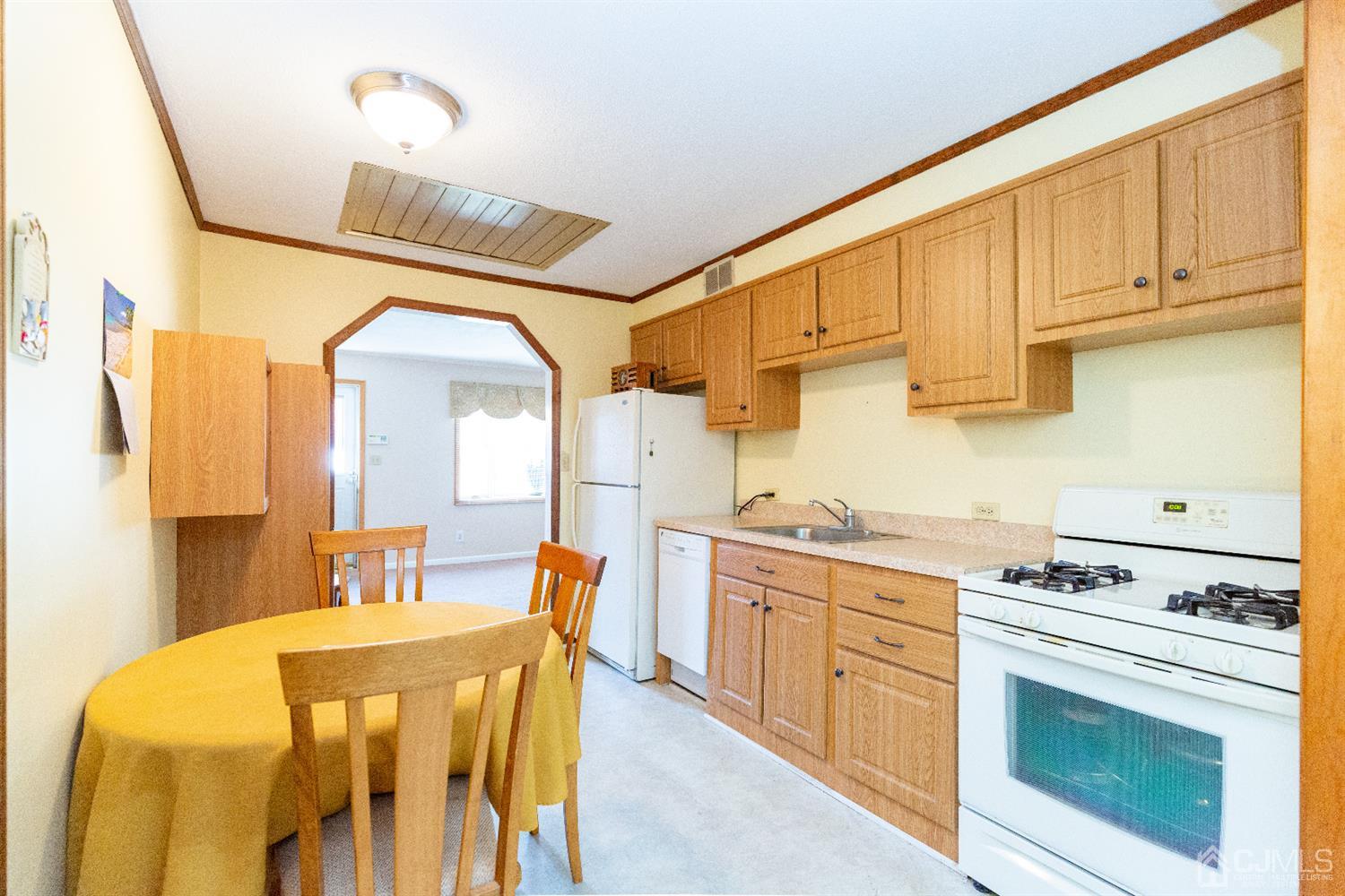 1 Crescent Road Edison, NJ 08817 - Photo 10 of 36 a kitchen with stainless steel appliances a stove a sink dishwasher and cabinets with wooden floor