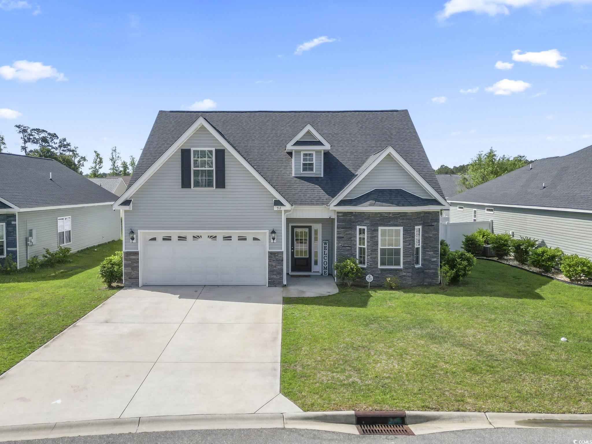 712 Hobonny Loop Longs, SC 29568 - Photo 1 of 39 Traditional home with a garage, a front yard, stone siding, and concrete driveway