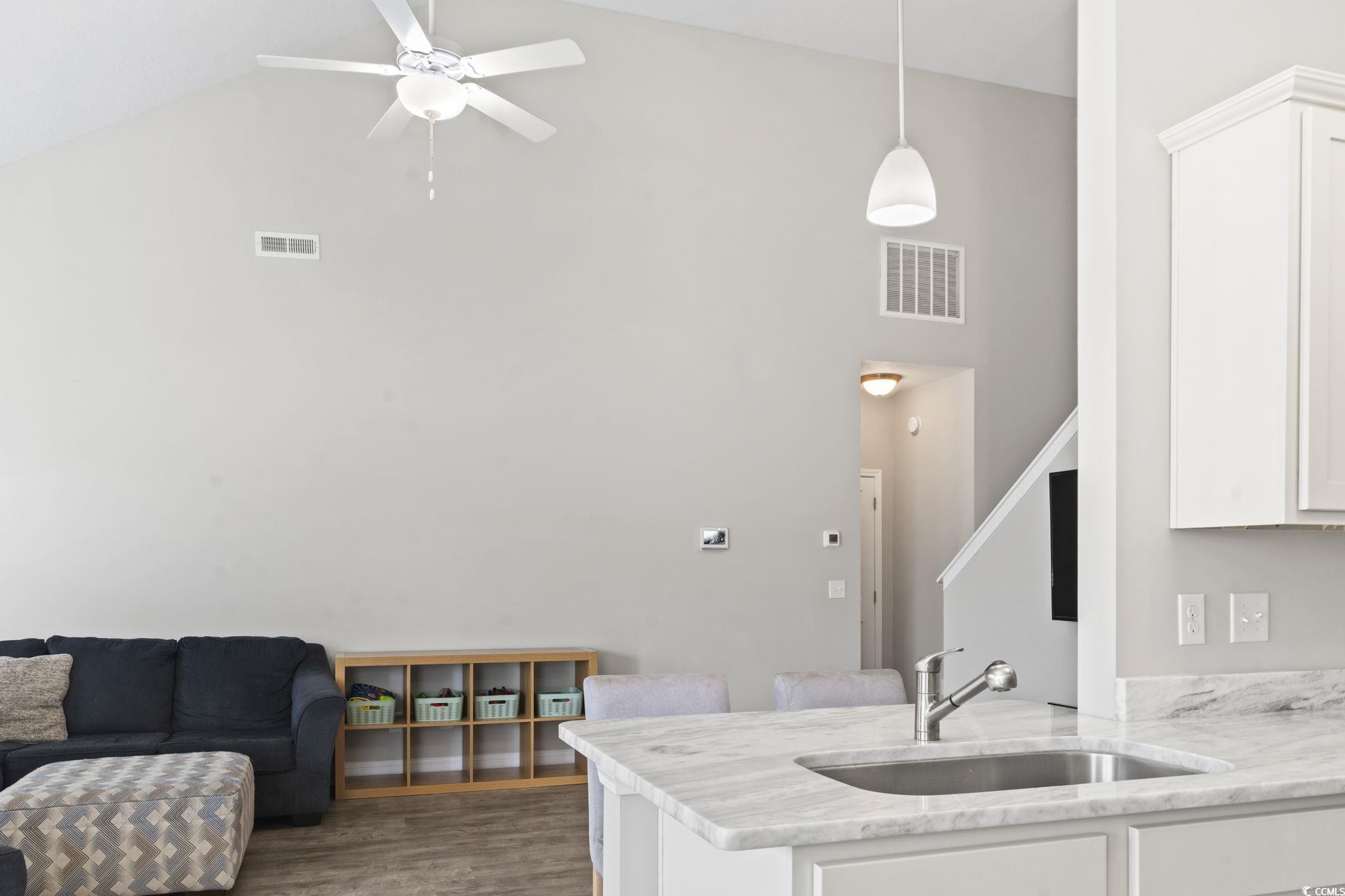 712 Hobonny Loop Longs, SC 29568 - Photo 14 of 39 Kitchen featuring visible vents, a sink, white cabinetry, and high vaulted ceiling