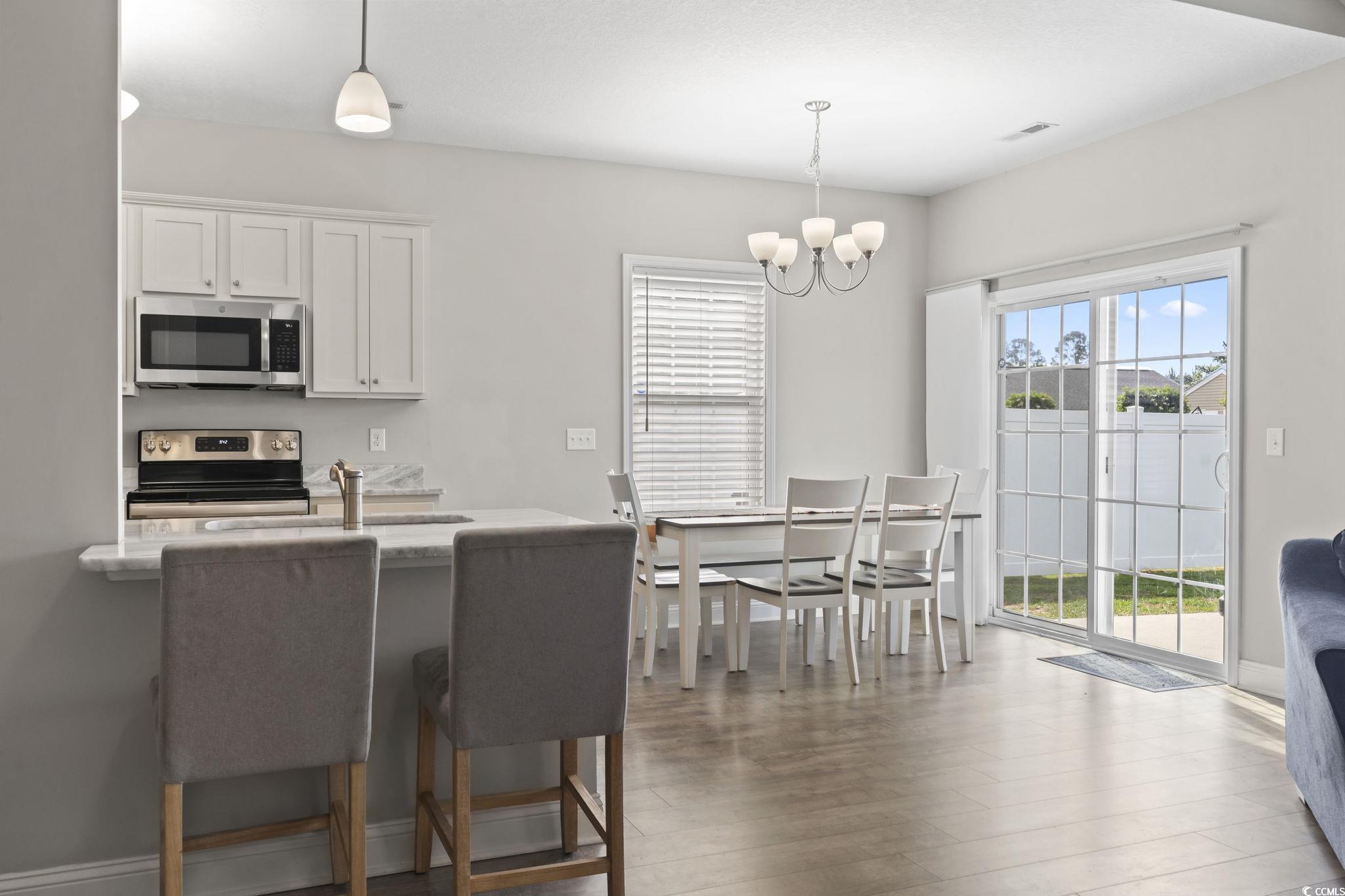 712 Hobonny Loop Longs, SC 29568 - Photo 15 of 39 Kitchen with white cabinetry, a chandelier, decorative light fixtures, and stainless steel appliances
